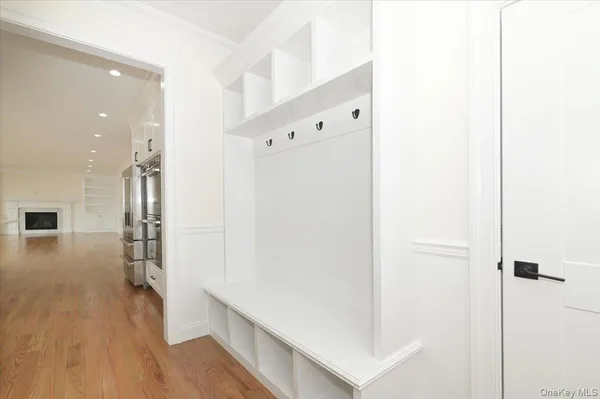 a view of hallway with stairs and wooden floor