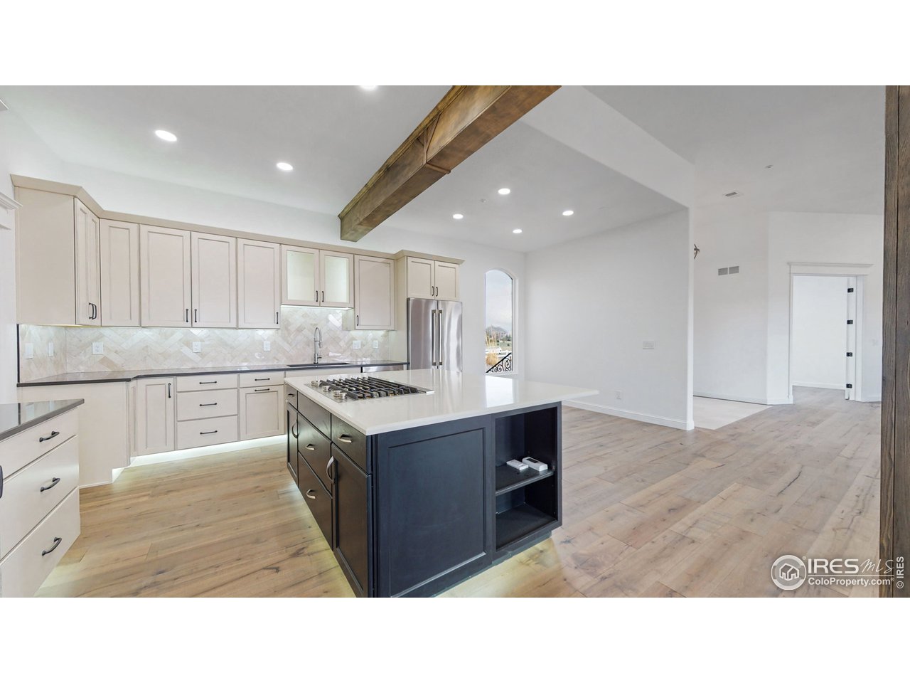 424 Grayhawk Road Fort Collins, CO 80524 - Photo 11 of 40 a kitchen with kitchen island sink stove and white cabinets