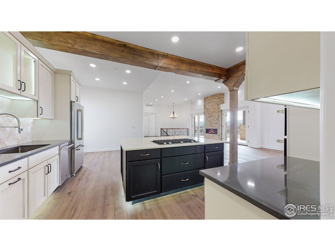424 Grayhawk Road Fort Collins, CO 80524 - Photo 12 of 40 a kitchen with stainless steel appliances kitchen island granite countertop a sink refrigerator and cabinets