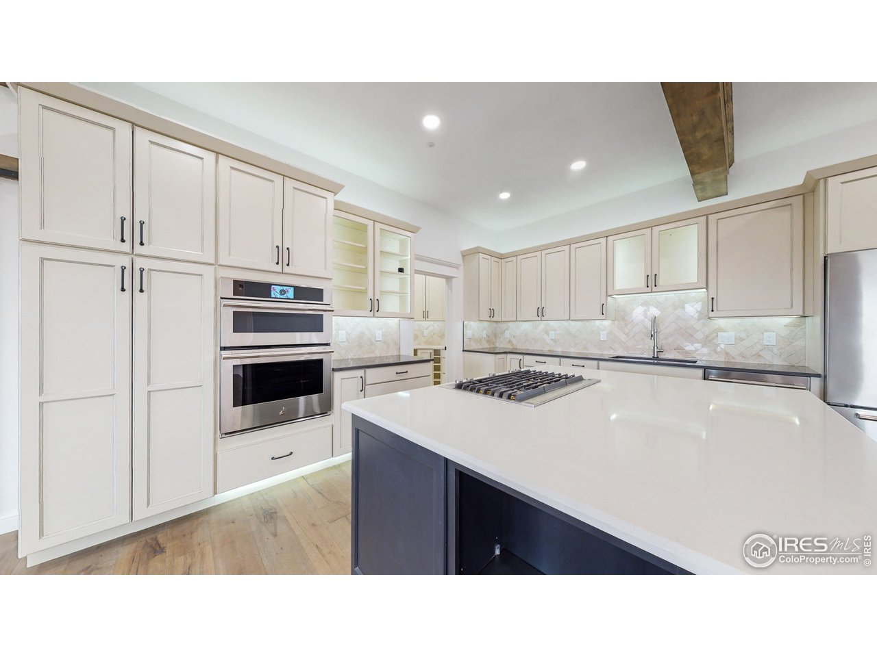 424 Grayhawk Road Fort Collins, CO 80524 - Photo 13 of 40 a kitchen with stainless steel appliances a refrigerator sink and cabinets