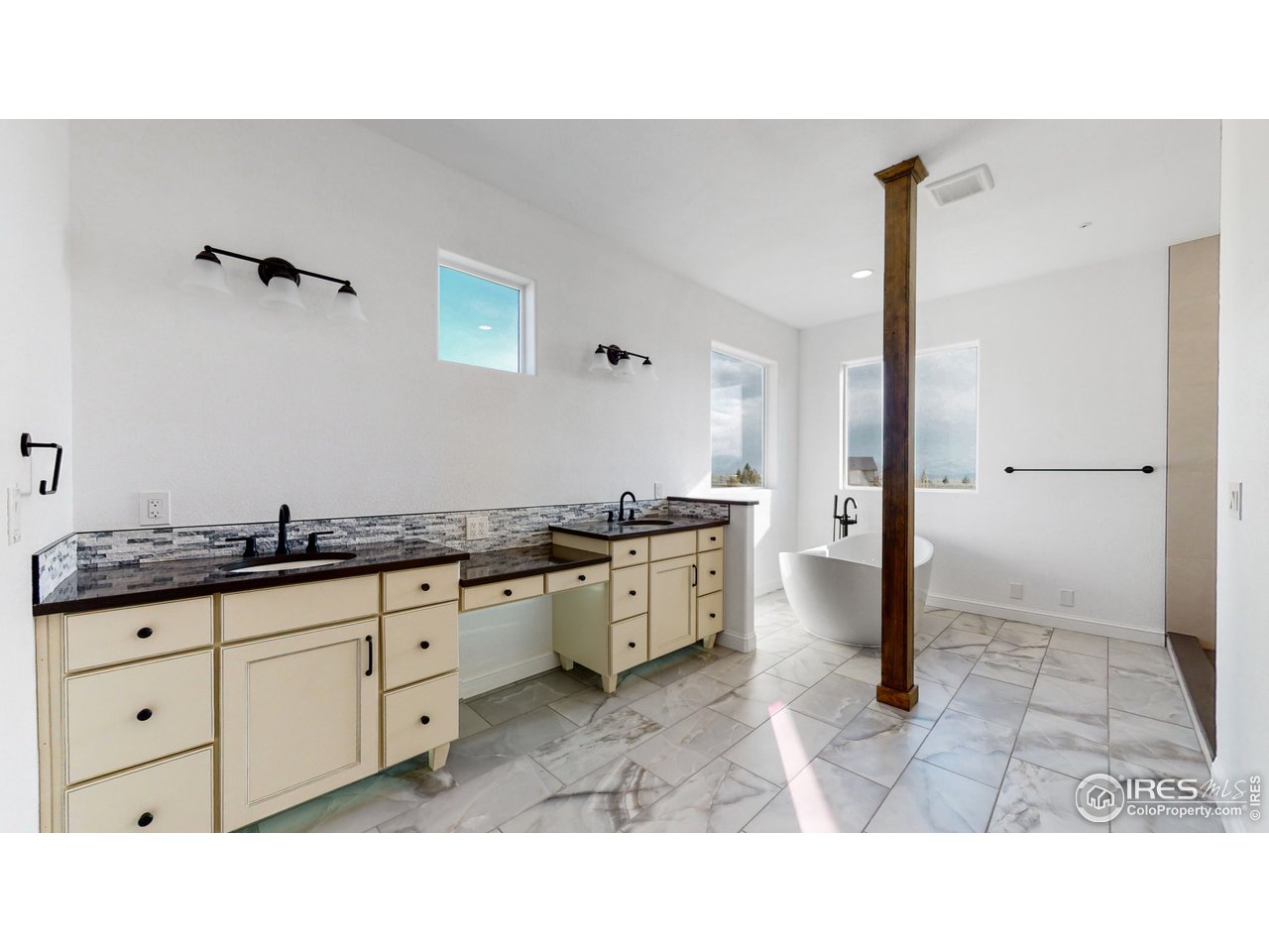 424 Grayhawk Road Fort Collins, CO 80524 - Photo 20 of 40 a bathroom with a sink a granite counter top a toilet a sink and a mirror