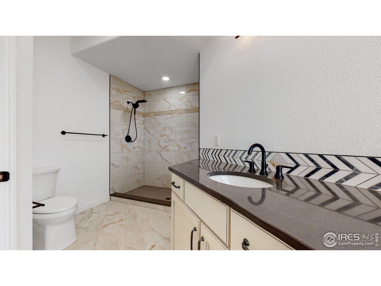 424 Grayhawk Road Fort Collins, CO 80524 - Photo 25 of 40 a bathroom with a sink a toilet and shower