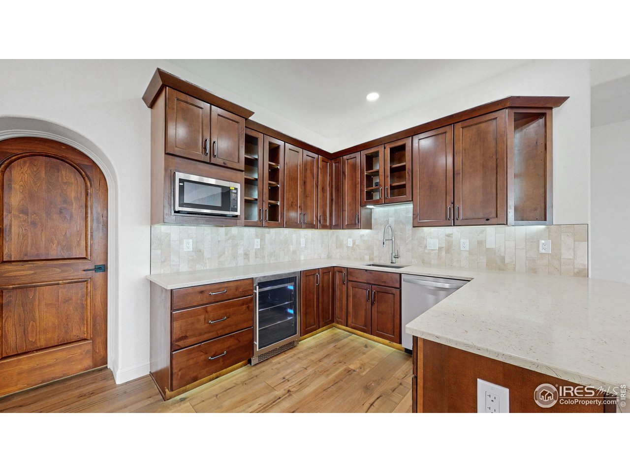 424 Grayhawk Road Fort Collins, CO 80524 - Photo 7 of 40 a kitchen with kitchen island cabinets a sink and a stove