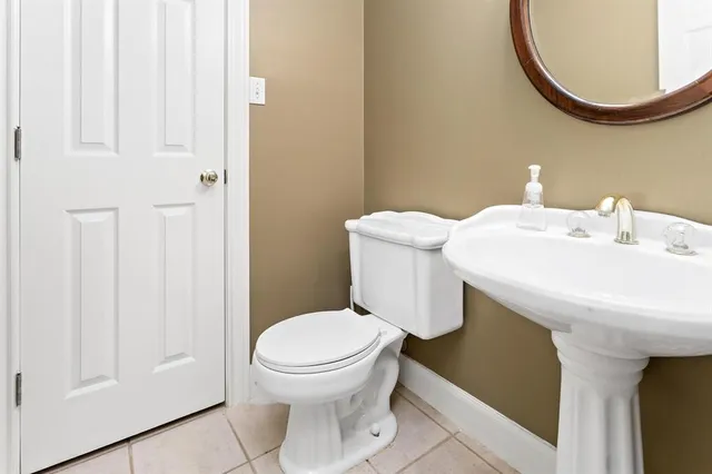 a bathroom with a sink a toilet and a mirror