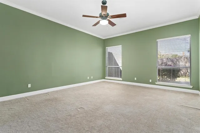 a view of a room with a ceiling fan and a window