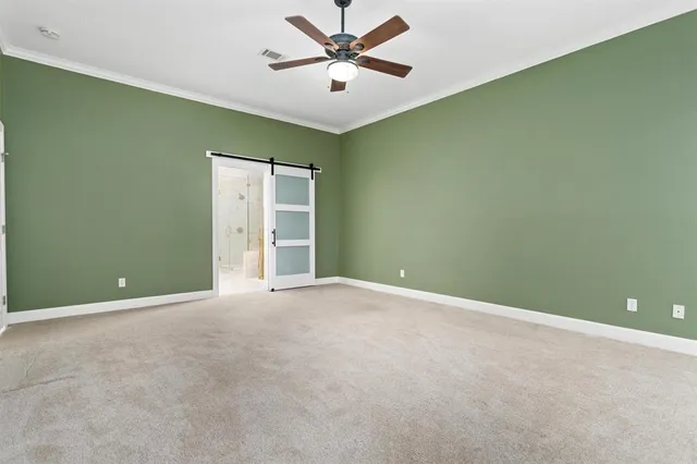 an empty room with a ceiling fan and a window
