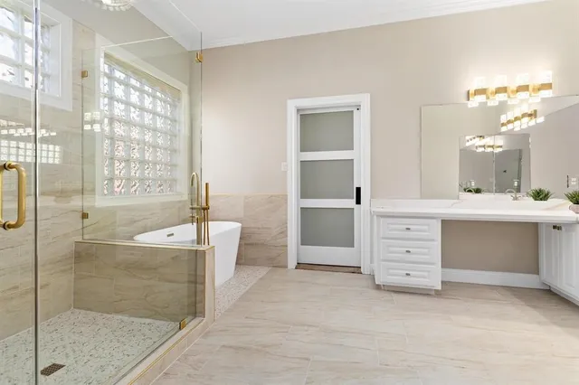 a bathroom with a double vanity sink a bathtub and shower