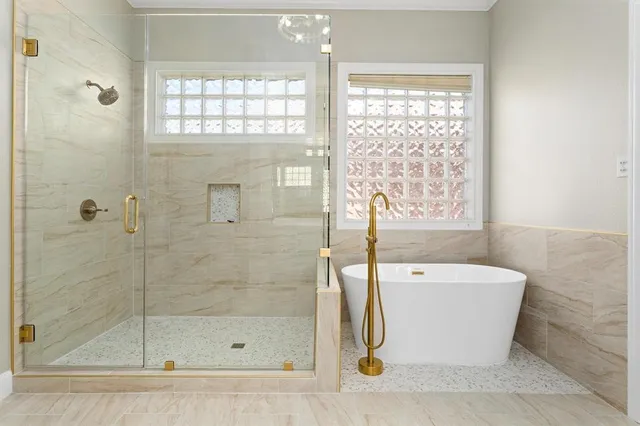 a bathroom with a bathtub and shower