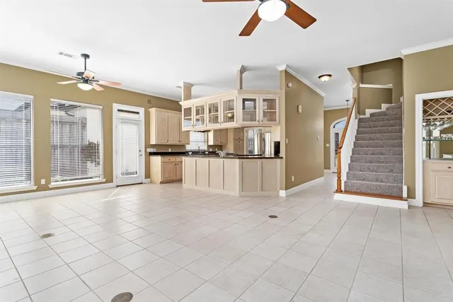 an empty room with fireplace and windows