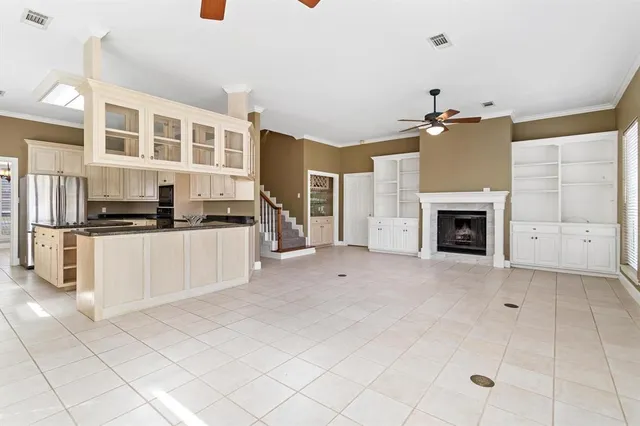 a view of kitchen with stainless steel appliances kitchen island granite countertop a refrigerator and a stove top oven