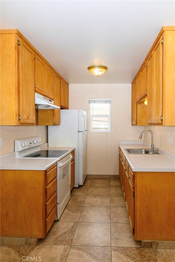 171 Brisco Road, Unit 8 Arroyo Grande, CA 93420 - Photo 4 of 23 a kitchen with a sink stove and cabinets