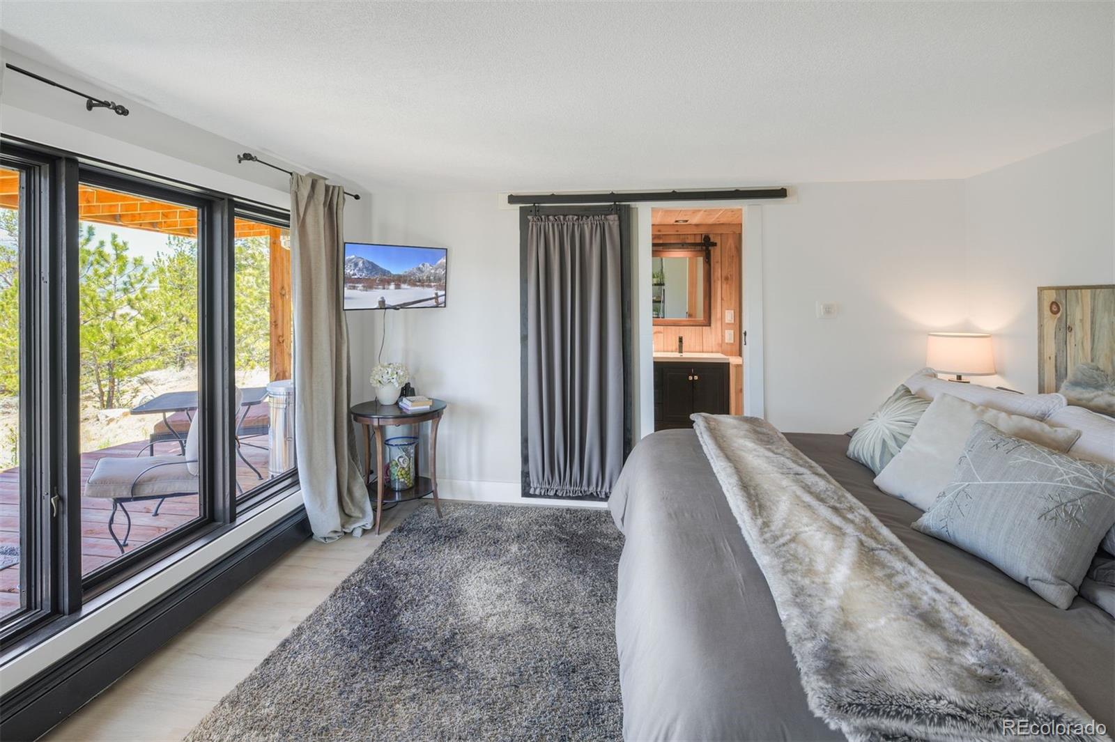 630 Reva Ridge Road Twin Lakes, CO 81251 - Photo 18 of 40 a bedroom with a large bed and a large window