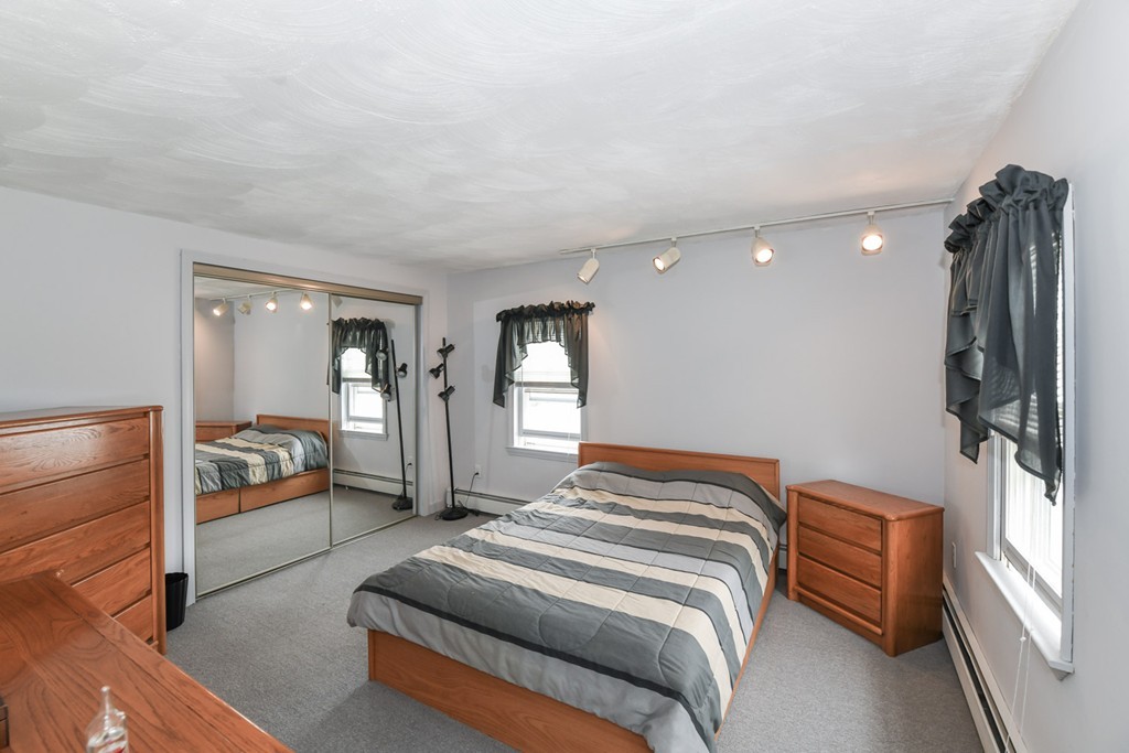 34 Clinton Street Waltham, MA 02453 - Photo 14 of 20 a bedroom with a bed and a walk in closet