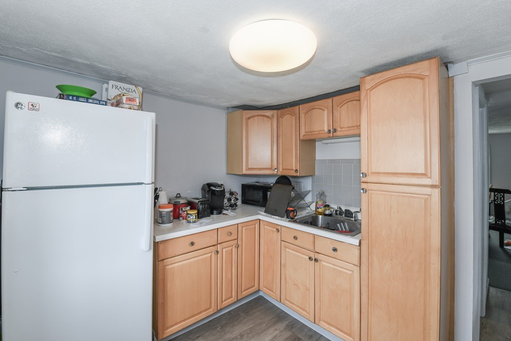 34 Clinton Street Waltham, MA 02453 - Photo 16 of 20 a kitchen with stainless steel appliances a refrigerator sink and white cabinets