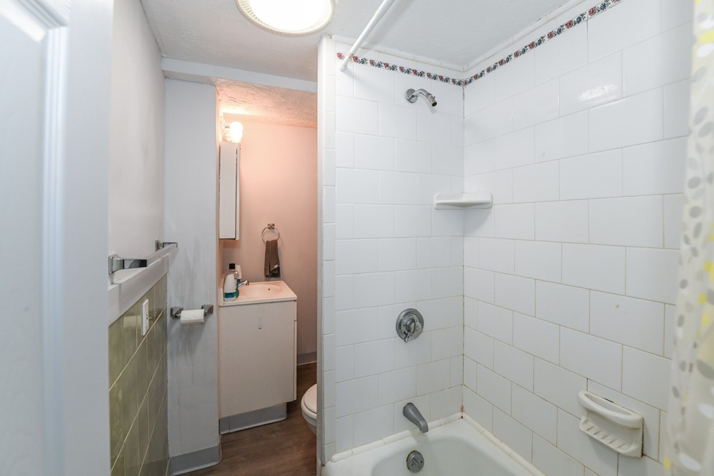 34 Clinton Street Waltham, MA 02453 - Photo 18 of 20 a bathroom with a sink a toilet and shower