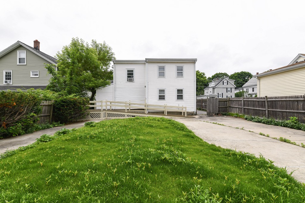 34 Clinton Street Waltham, MA 02453 - Photo 20 of 20 a view of a house with backyard and a garden