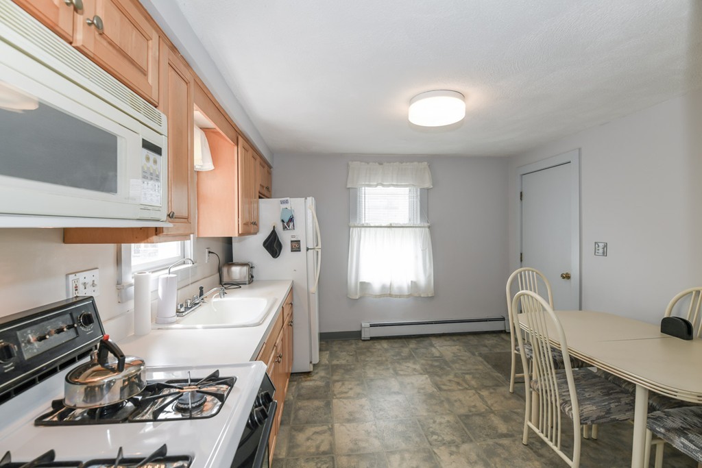 34 Clinton Street Waltham, MA 02453 - Photo 5 of 20 a living room with furniture a window and gym equipment
