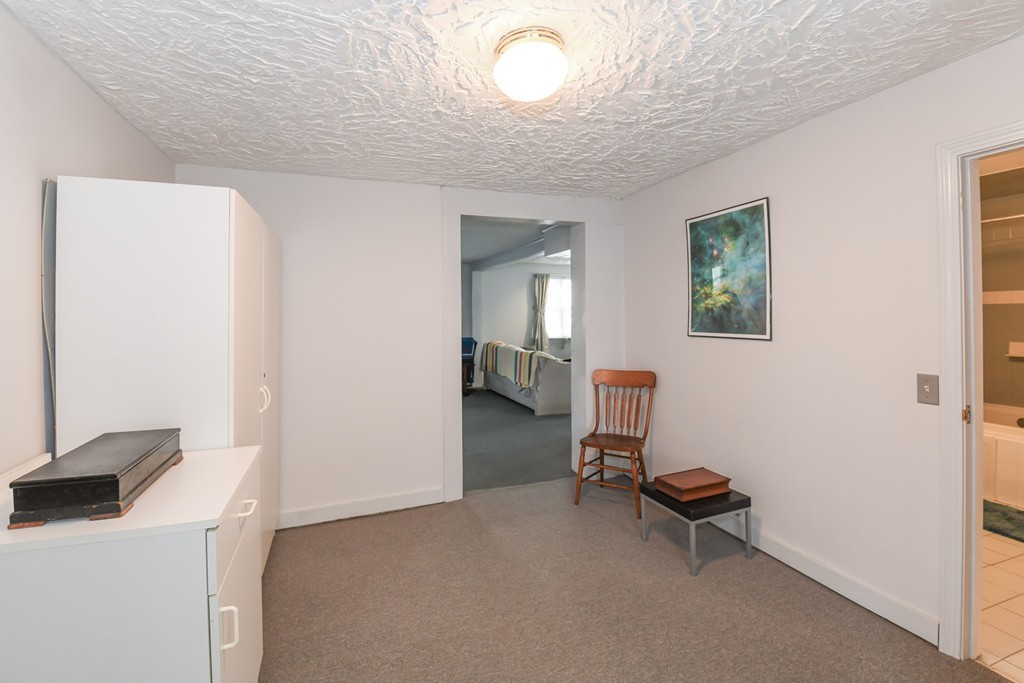 34 Clinton Street Waltham, MA 02453 - Photo 6 of 20 a room with a mirror and a table