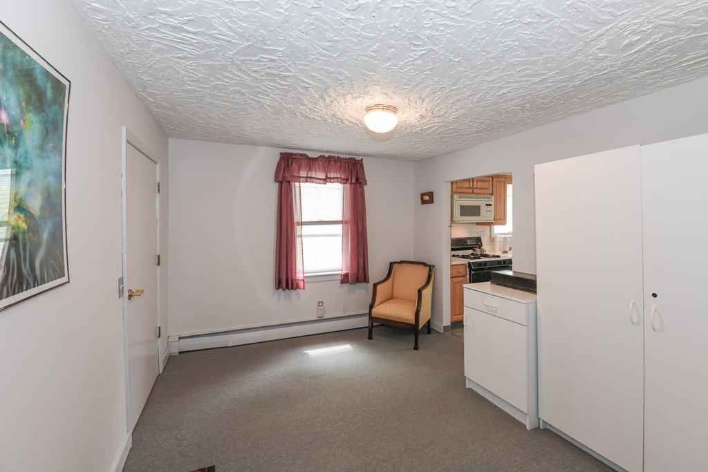 34 Clinton Street Waltham, MA 02453 - Photo 9 of 20 a living room with furniture and a window