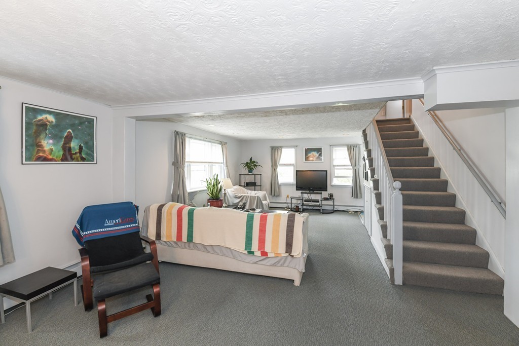 34 Clinton Street Waltham, MA 02453 - Photo 10 of 20 a living room with furniture and a flat screen tv