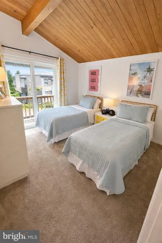 a spacious bedroom with two bed and a large window