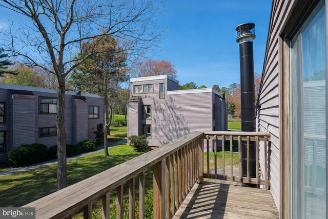 a view of a house with backyard and deck