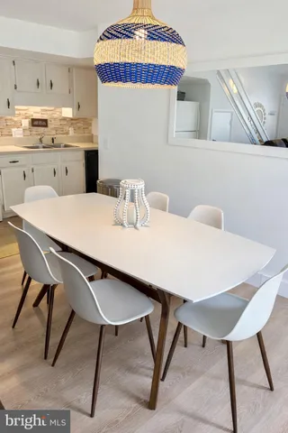 a kitchen with a table chairs and a refrigerator