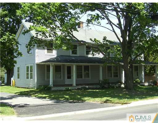 404 Ridge Road Dayton, NJ 08810 - Photo 2 of 3 a view of a brick house with a large windows and large trees