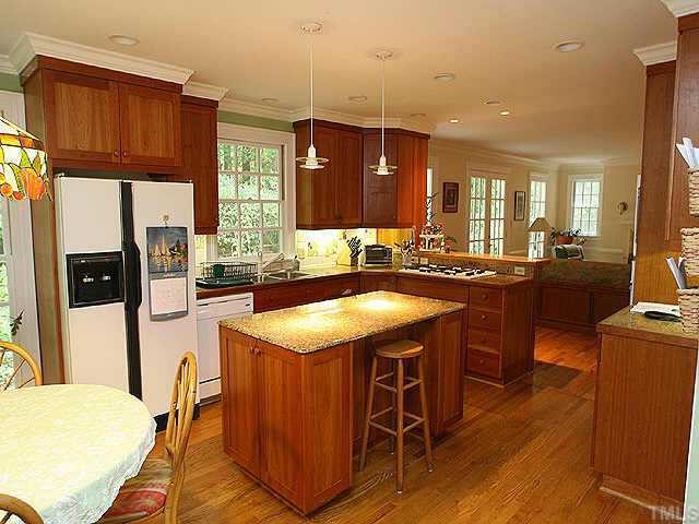 2004 Rangecrest Road Raleigh, NC 27612 - Photo 2 of 10 a kitchen with stainless steel appliances granite countertop a sink a stove and a refrigerator