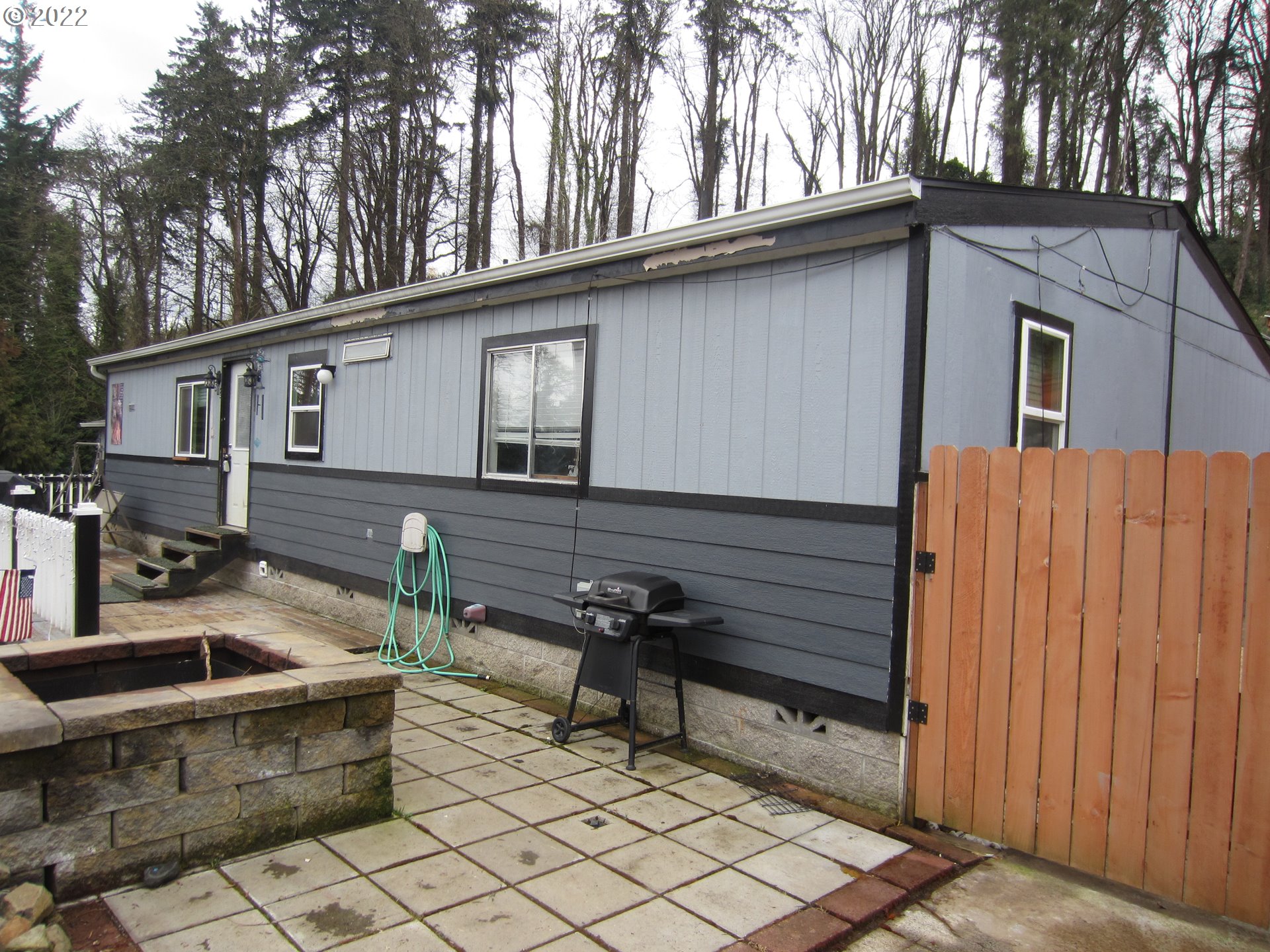a side view of a house with backyard