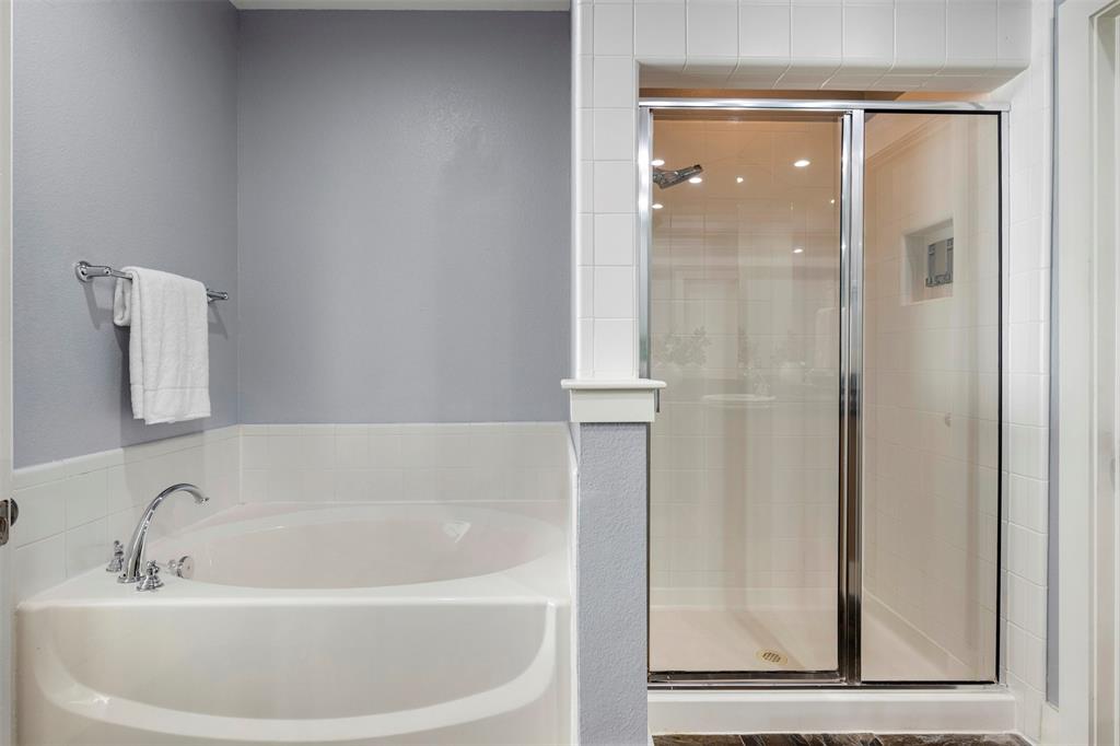 4830 Cedar Springs Road, Unit 30 Dallas, TX 75219 - Photo 17 of 32 a white bath tub sitting next to a window