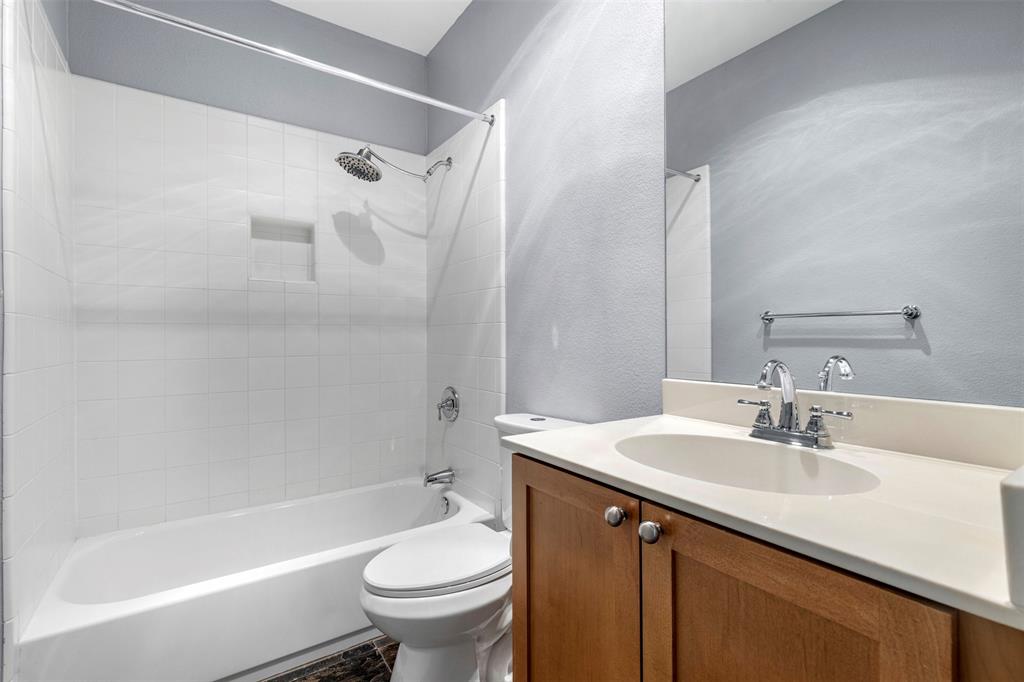 4830 Cedar Springs Road, Unit 30 Dallas, TX 75219 - Photo 21 of 32 a bathroom with a sink toilet and shower