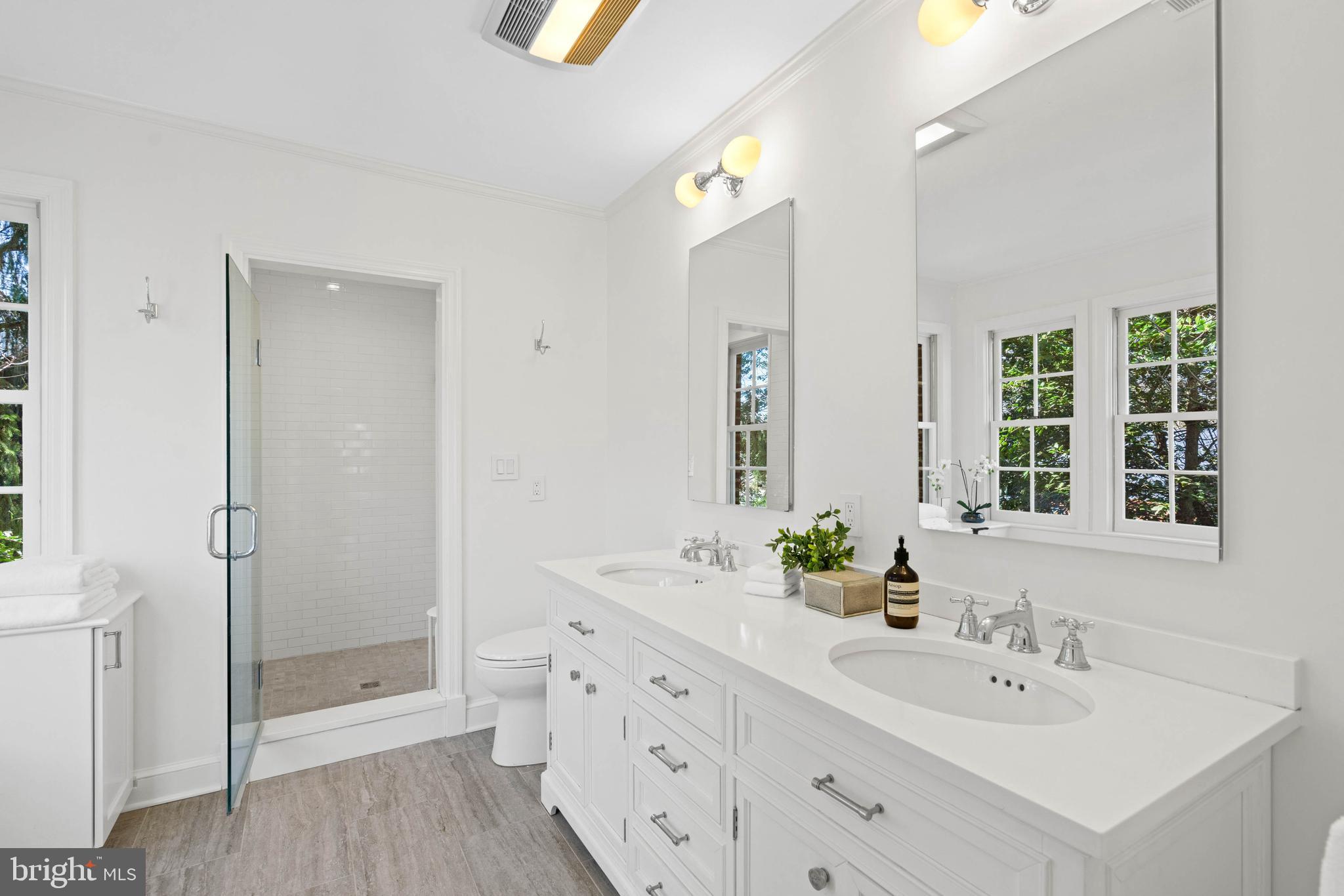 3549 Springland Lane Northwest Washington, DC 20008 - Photo 21 of 47 a bathroom with a double vanity sink toilet and shower