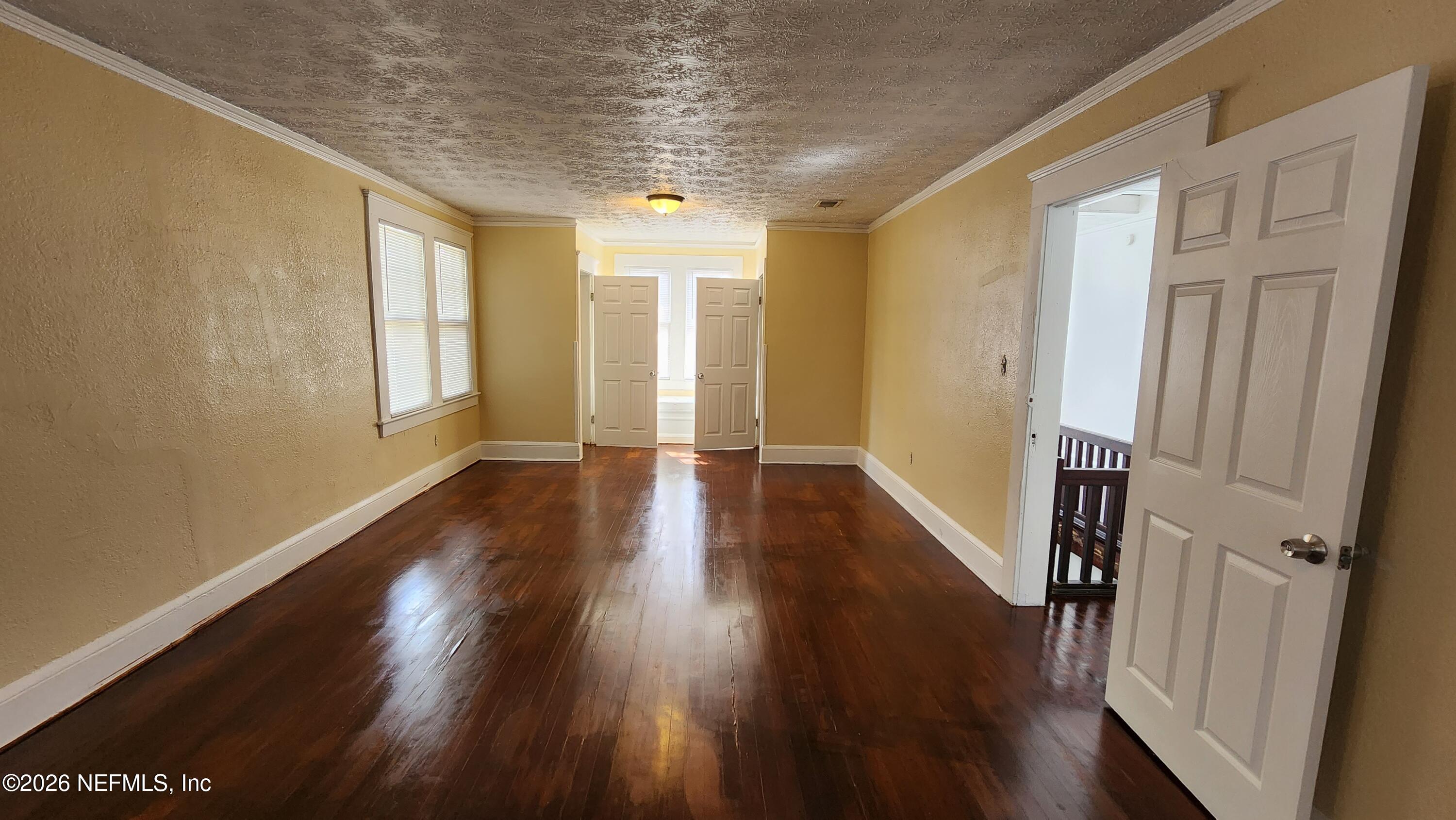 2036 Moncrief Road Jacksonville, FL 32209 - Photo 15 of 32 a view of a hallway with wooden floor and stairs