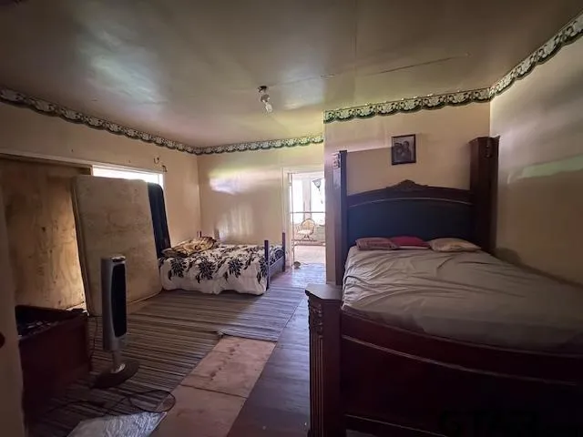 a bedroom with a bed mirror and couch
