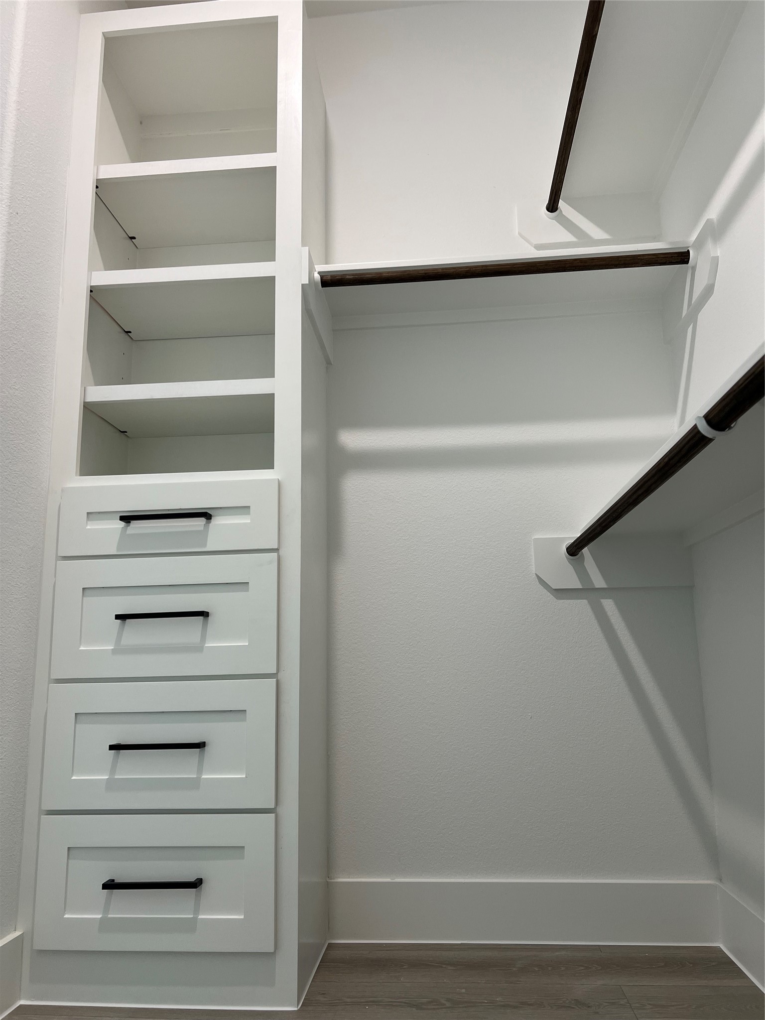 7107 Foster Street, Unit B Houston, TX 77021 - Photo 12 of 18 Spacious walk-in primary closet featuring built-in shelving, drawers, and ample hanging space for organized storage.