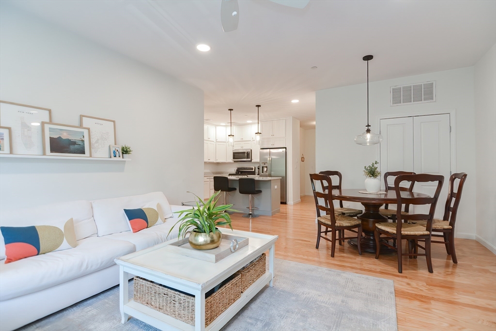 200 Revere Street, Unit 4108 Canton, MA 02021 - Photo 12 of 33 a living room with furniture kitchen view and a dining table