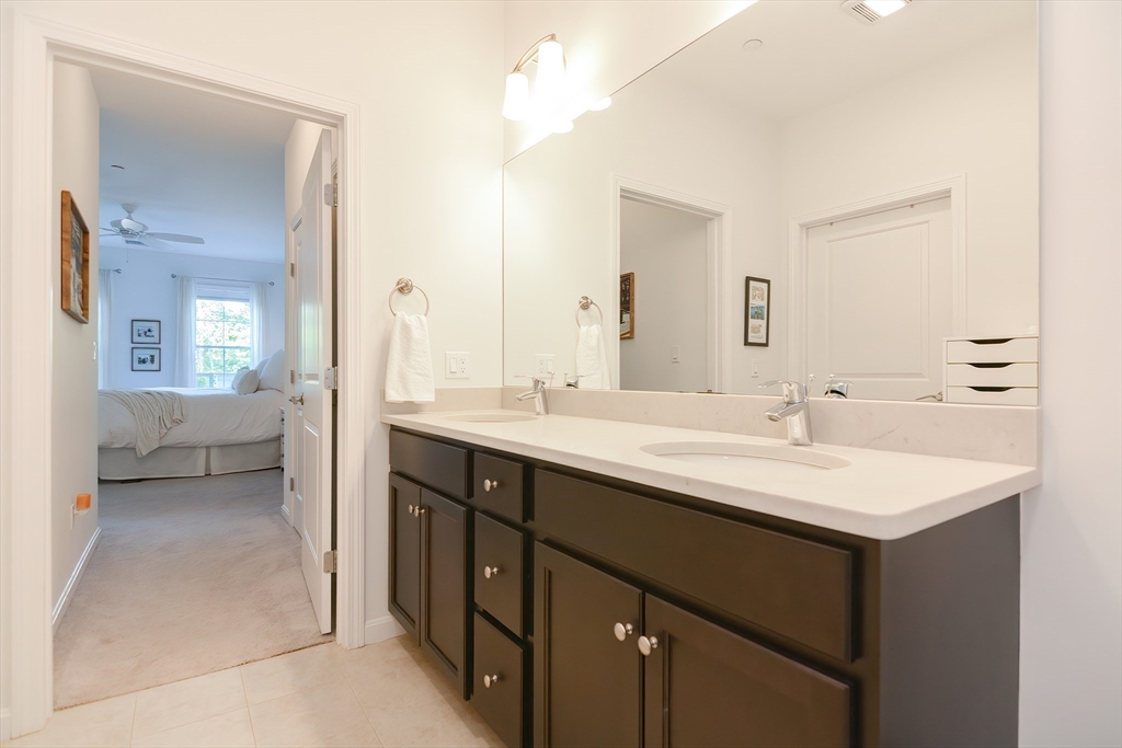 200 Revere Street, Unit 4108 Canton, MA 02021 - Photo 17 of 33 a en suite bathroom with a double vanity sink a mirror and a