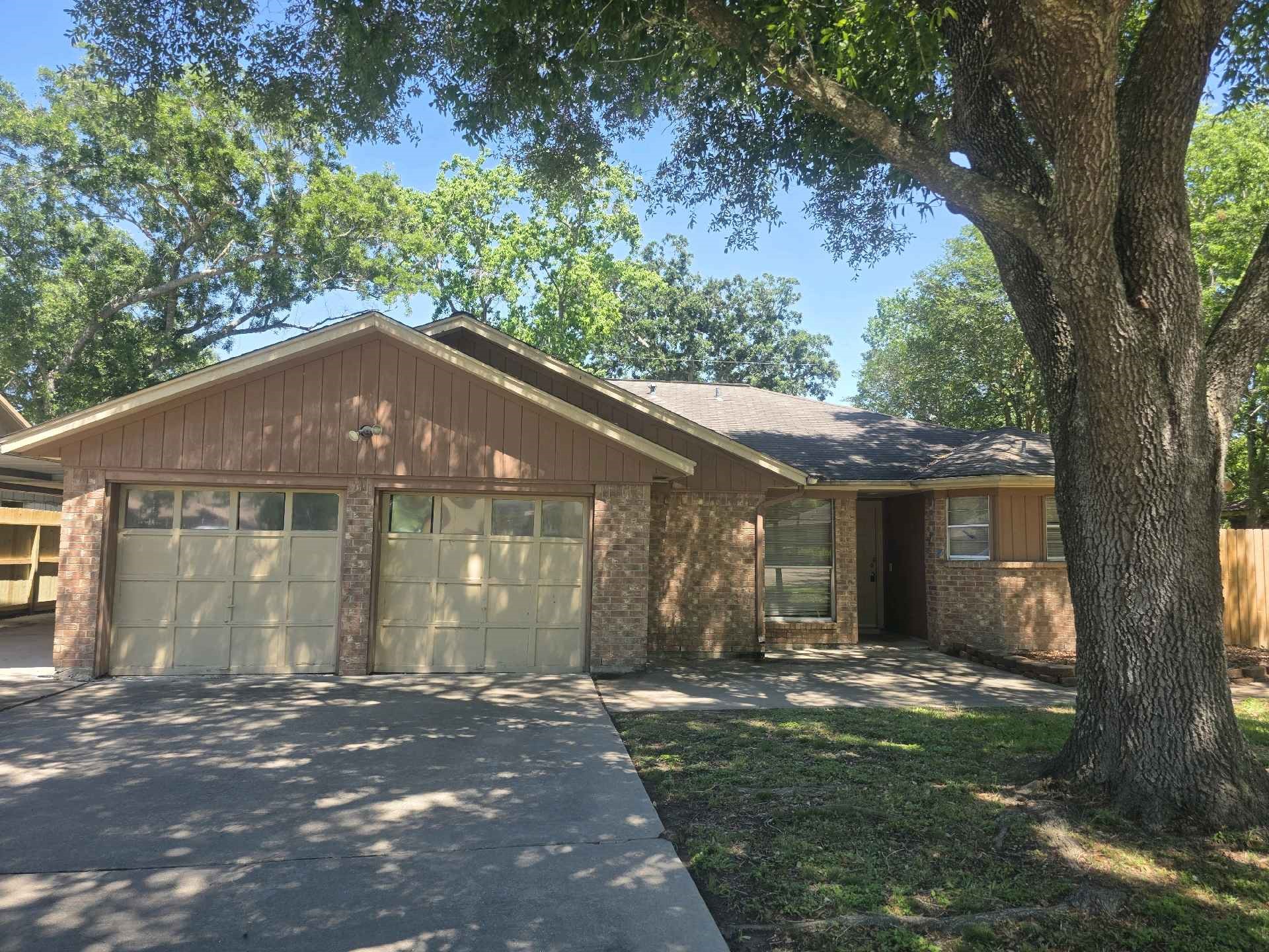 5006 Timber Ridge Street Baytown, TX 77521 - Photo 1 of 6 a front view of a house with a yard