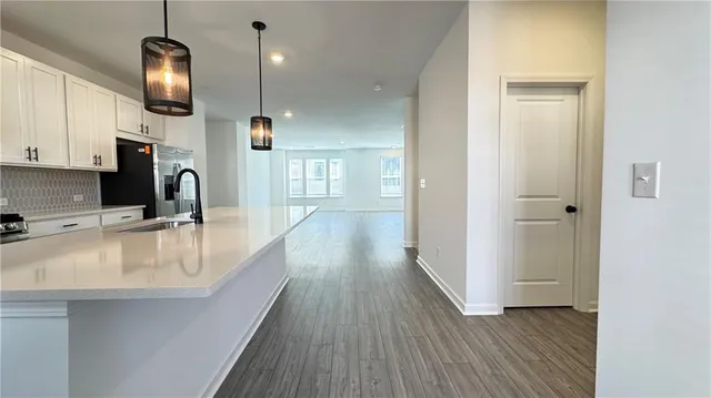 a kitchen with a sink and a refrigerator