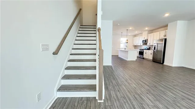 a view of a kitchen with wooden floor and electronic appliances