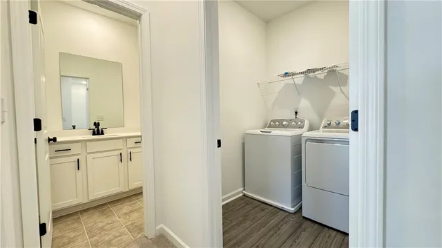 a room with a sink and wooden floor