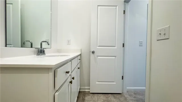 a bathroom with a sink and mirror
