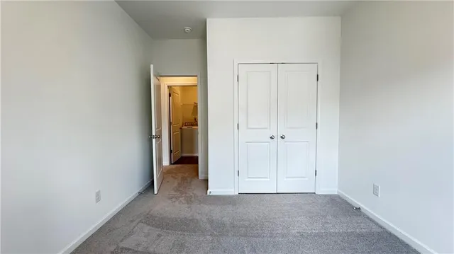 an empty room with closet area