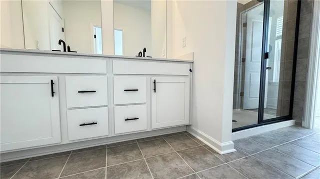 a bathroom with a shower and a mirror