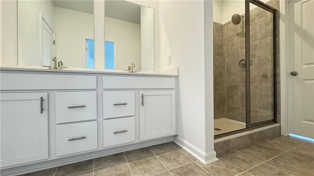 a bathroom with a glass shower door