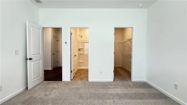an empty room with closet and mirror