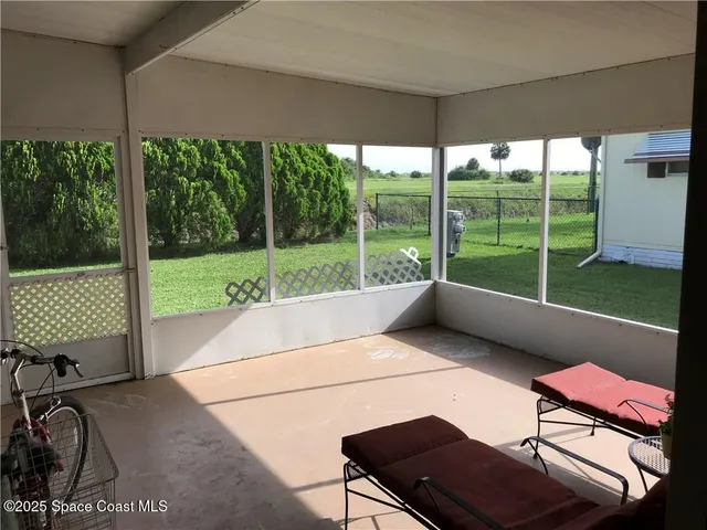 a living room with a large window and yard