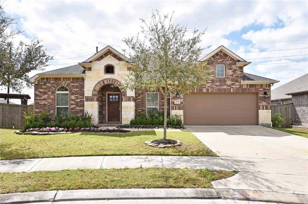 26307 Cloverbank Lane Richmond, TX 77406 - Photo 1 of 44 Welcome to 26307 Cloverbank in Creekside Ranch. This beauty backs to a pond - to back neighbors. The brick and stone elevation are lovely on this home.