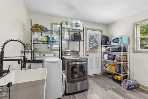 a view of a kitchen with fridge and wooden floor